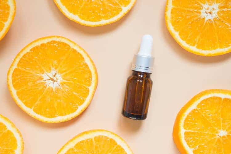 image showing a serum bottle surrounded by orange slices